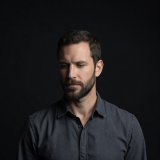 Portrait of contributor Tobias Reed against a dark background